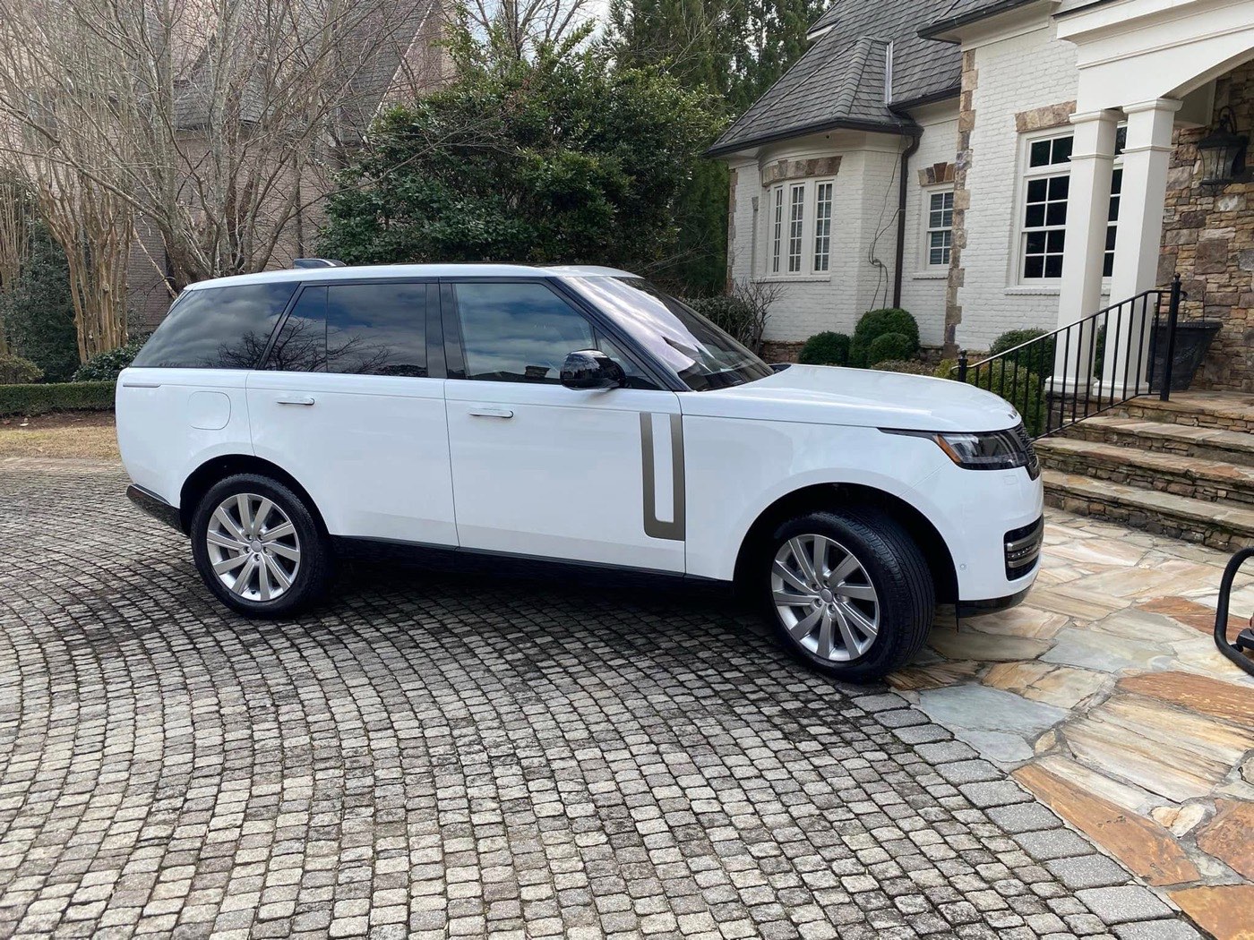 Freshly detailed white Range Rover in a driveway